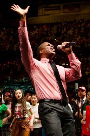 A singer shows his emotion as he praises God during the World Discipleship Summit.