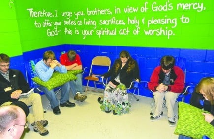 With the words of Romans 12:1 painted on the wall behind them