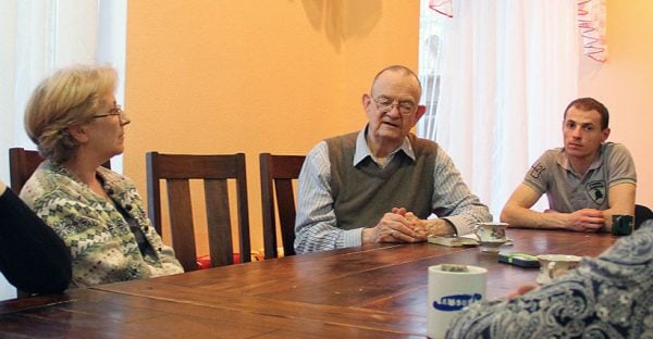 Jim Noyes, center, speaks with refugees from eastern Ukraine in Kyiv during a Christian Chronicle interview in 2015.