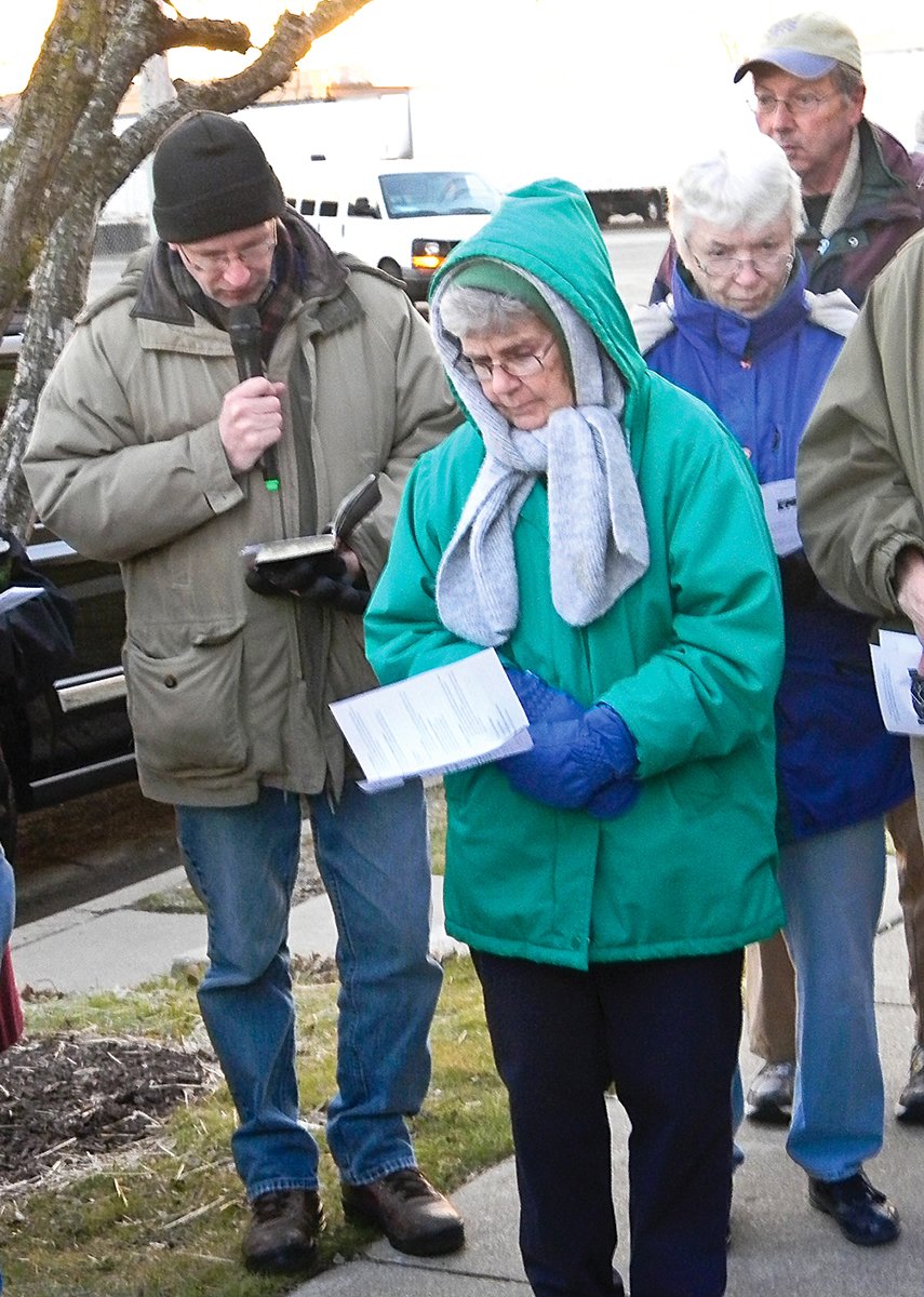 Church of Christ minister Bobby Lawson prays at a vigil at a federal deportation center west of Chicago.