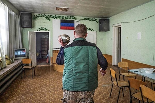 A separatist fighter carries a live artillery shell through the former meeting place of the Petrovsky Church of Christ in Donetsk, Ukraine. Militants seized the building in October 2014 and renamed the region the Donetsk People’s Republic. 
