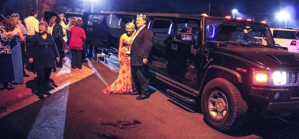 “King” Austin Peters basks in the spotlight of Night to Shine as he and his volunteer buddy prepare to board a limousine.