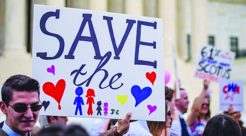 An opponent of same-sex marriage holds up a poster near the steps of the U.S. Supreme Court in Washington, D.C., just before the court’s 5-4 decision.