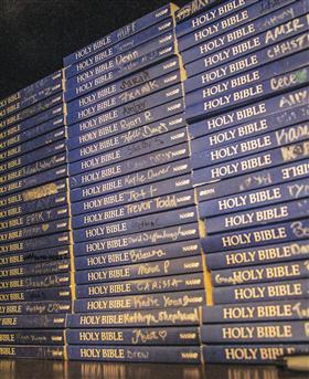 The names of regular devo attendees — and visitors — can be seen on the new Bible shelf at the Legers’ home in Newcastle, Okla. (PHOTO BY ERIK TRYGGESTAD)