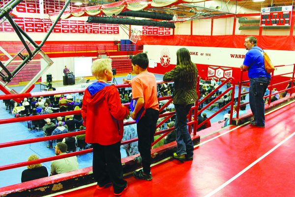 Children watch from the bleachers during a session of the Alaska Statewide Lectureship at the Wasilla High School gymnasium.