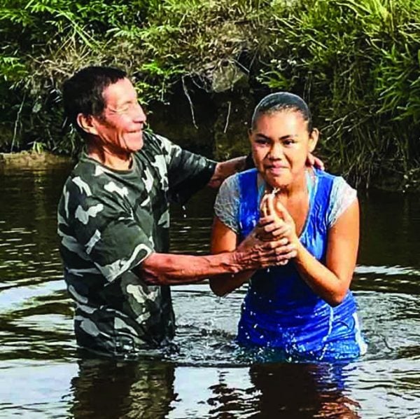 Monkey Mountain minister Paul Daniels baptizes one of four youths immersed during a mission trip by the Amelia's Ward team.