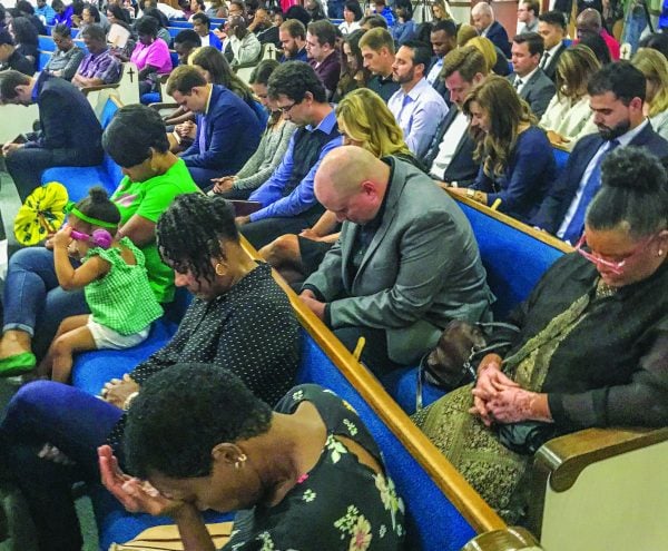 Loved ones, including friends, relatives and fellow Christians, pray Saturday night at a prayer vigil in Botham Shem Jean's memory. The Dallas West Church of Christ hosted the vigil.