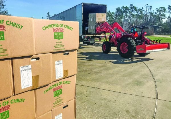 Deacon Austin Boyd uses a forklift-equipped tractor to help unload the disaster relief trailer at the Jenks Avenue Church of Christ in Panama City, Fla.