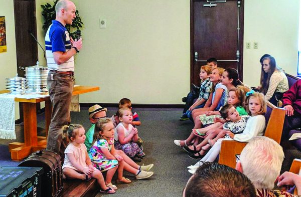 Children gather at the Springbrook Church of Christ in Kent, Wash., front of the auditorium to practice what they’ve learned.