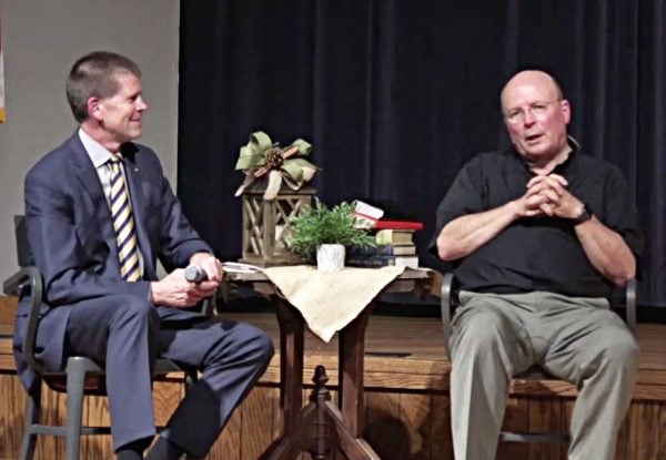 John deSteiguer, president of Oklahoma Christian University, speaks to theologian and author Scot McKnight in the university's Baugh Auditorium.