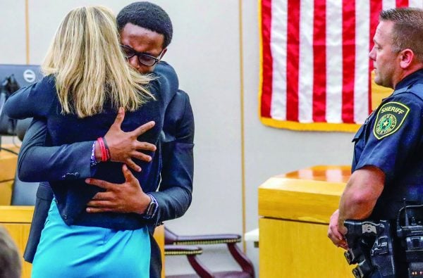 Botham Jean’s younger brother Brandt Jean hugs convicted murderer and former Dallas police officer Amber Guyger after delivering his impact statement.