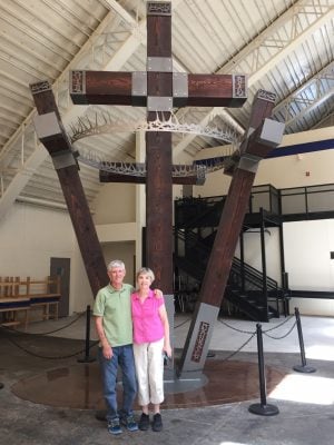 Darrell and Anita Price stand in front of the four-cross sculpture that their son, Aaron Price, created to be displayed at Lubbock Christian University in Texas.