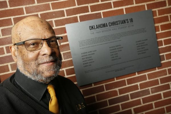 Robert Edison, the new Distinguished Visiting Professor of American Studies in Racial and Ethnic Diversity at Oklahoma Christian University, stands near a plaque at OC's Benson Hall with his name on it.
