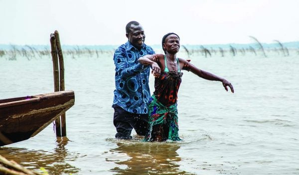Jean Kado, a 1998 graduate of the Benin Bible Training Center, baptizes a new believer in rural West Africa.