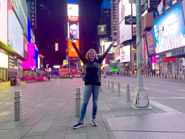Kym Langford stands in the middle of Times Square. The area was practically empty due to shelter in place orders.