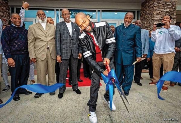 Minister Orpheus Heyward cuts a ribbon at a building dedication for the Renaissance Church of Christ in Atlanta, financed by The Solomon Foundation.