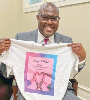 Little Rock Mayor Frank Scott Jr. holds a T-shirt for Project Hope