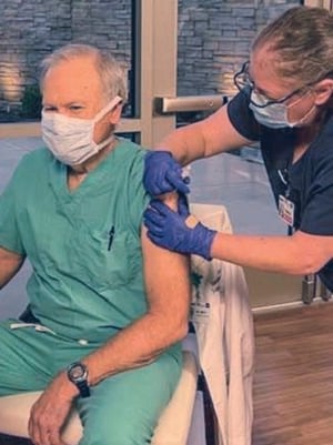 Dr. David Smith receives his COVID-19 vaccine in Little Rock, Ark. “Too many of my patients are dying every day” from the virus, said the church member and medical missionary to Haiti.