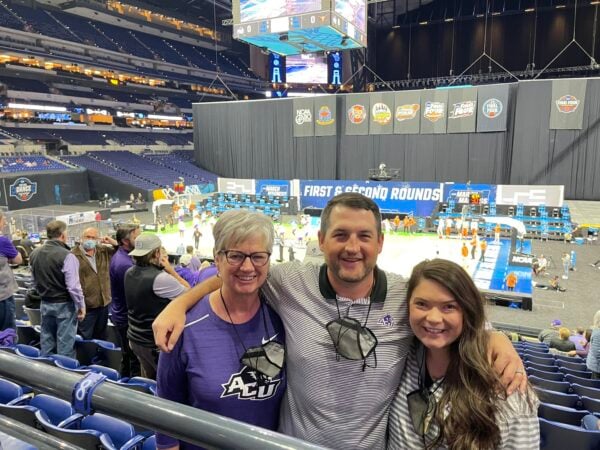 Cheryl Mann Bacon, at left, with her Michael and daughter-in-law Sarah at Lucas Oil Stadium in Indianapolis. 