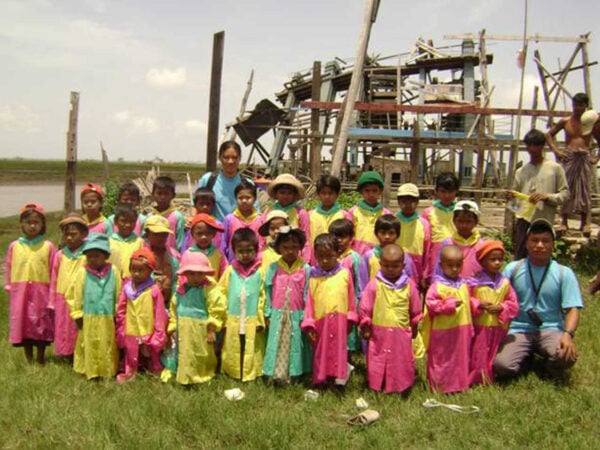 School children in Myanmar show off the ponchos they received from Partners in Progress.