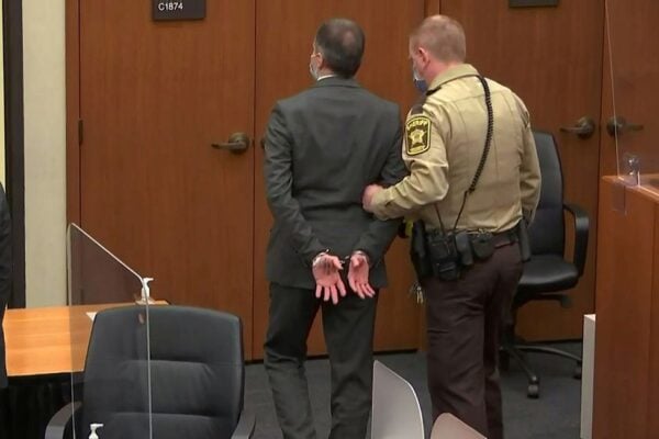 A sheriff’s deputy leads a handcuffed Derek Chauvin out of the courtroom after the former police officer was found guilty of murdering George Floyd.