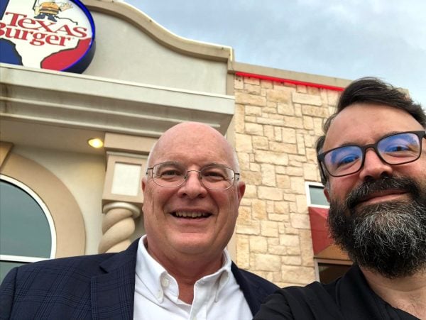 Erik Tryggestad and Westside Minister Mike Vestal eat at Texas Burger.