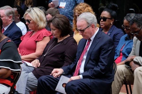 Friends and fellow Christians pray at the memorial dedication.