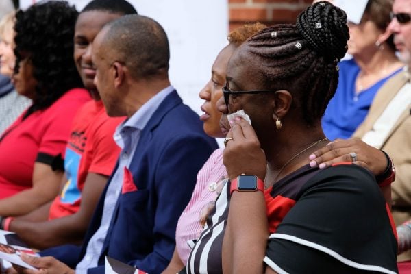 Allison Jean, right, wipes a tear at the dedication ceremony. Seated beside her, from right, are Botham Jean's older sister, Allisa Charles-Findley; his father, Bertrum Jean; and his younger brother, Brandt Jean.