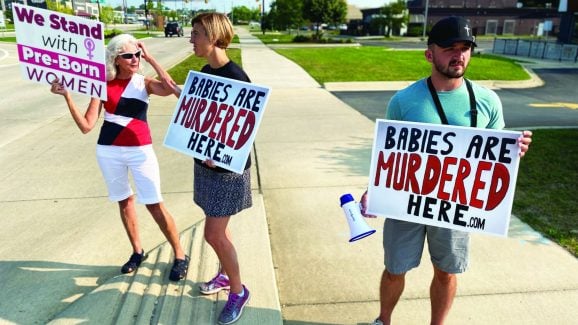 Picket signs, honking horns and sidewalk sermons: Inside an anti-abortion ministry