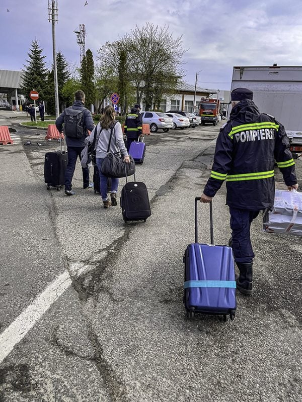 Border volunteers in Siret, Romania, help visitors bound for Ukraine with their bags.