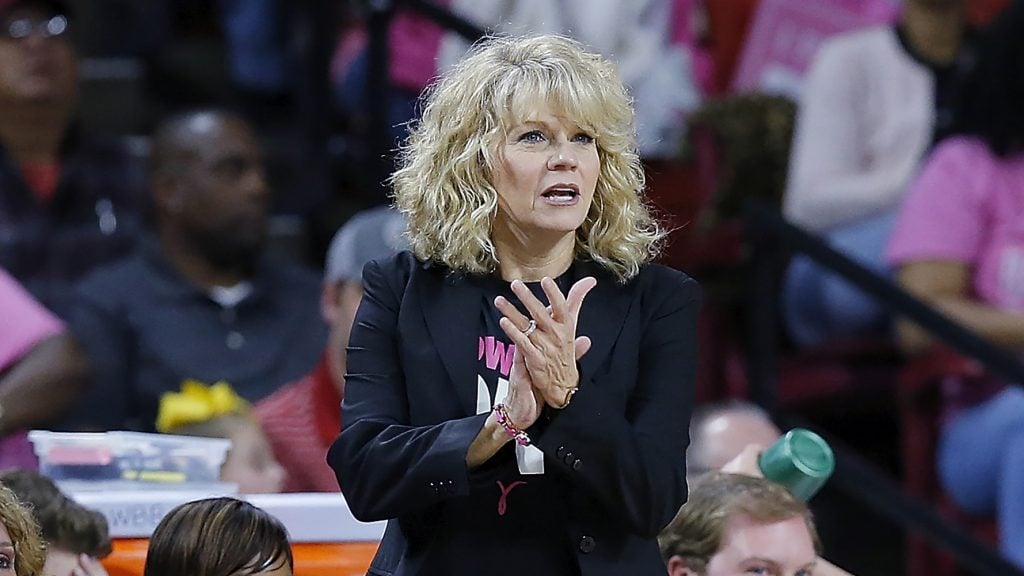 Sherri Coale, author of the new book “Rooted to Rise,” cheers on her team during her time as women’s basketball coach at the University of Oklahoma.