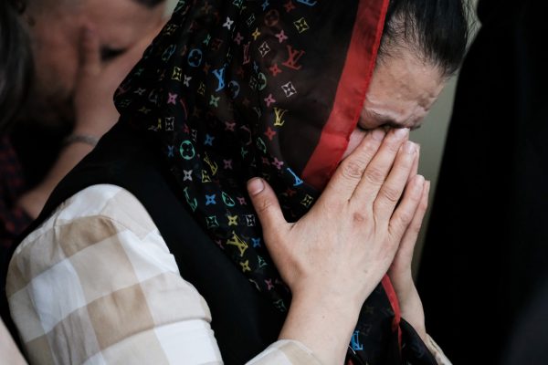 Victoria Virkhovska prays for soldiers, including her son, In Ivano-Frankivsk, Ukraine, in 2022.