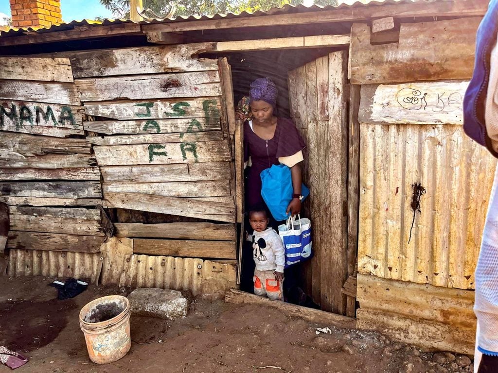 Joanne and her daughter leave their one-room home for Neema Village.