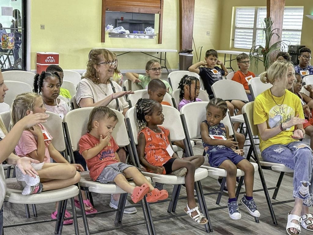 Children listen to a Bible lesson during a Vacation Bible School hosted by the East End Church of Christ on the island of Grand Cayman. The Pawlit family — Jousha, Jessica, Jackson, Addison and Emerson — coordinated the event.