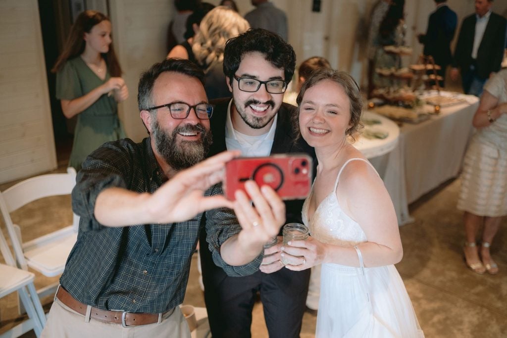 Erik Tryggestad takes a selfie with newlyweds James and Sarah Walter.