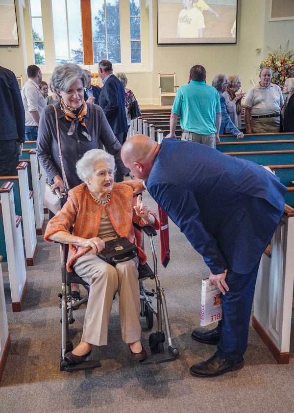 After worship, minister Chad Hedgepath, greets Caroline Cross, a founding member of the Heritage Church of Christ in Franklin, Tenn.