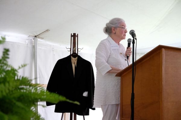 Jane Elam Hundley speaks at the 200th anniversary celebration. A suit worn by her late grandfather a century hangs behind her.