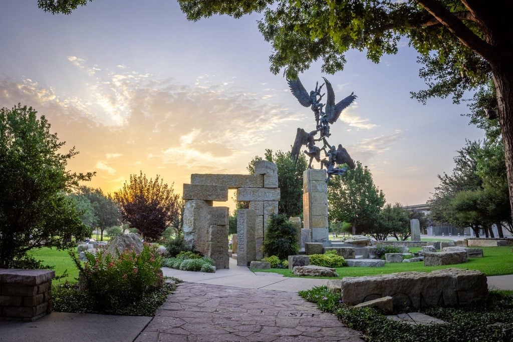 The Jacob's Dream sculpture at Abilene Christian University. The Williams Performing Arts Center can be seen in the distance.