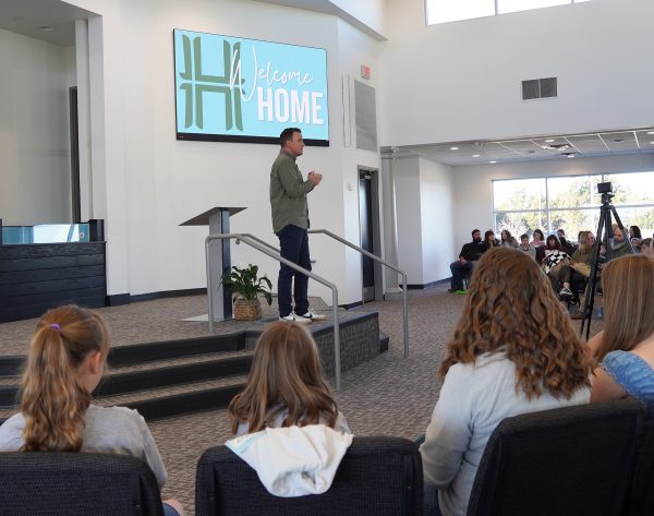 Travis Akins preaches during the grand opening service of the Heritage Church of Christ.