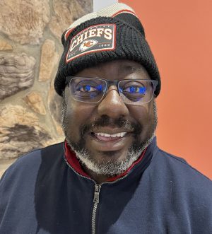 Church member Marcus Hicks sports a knit hat with a Kansas. City Chiefs logo.