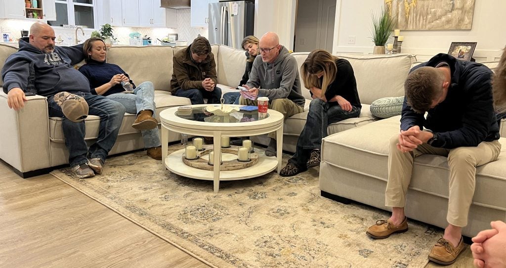 Walnut Street minister Chris McCurley, center, prays during a small-group meeting at his Tennessee home.