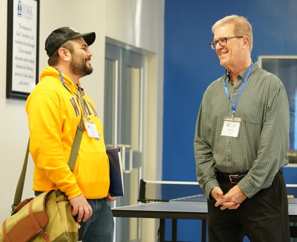 Jared Sanchez, left, from Dickinson, N.D., visits with Marvin Bryant from San Antonio during the Equip Conference.