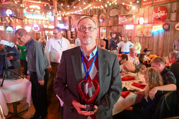 Michael Case, longtime Bible professor at York University, displays the Minister's Heart Award. Case was the inaugural recipient of the honor presented at the Equip Conference.