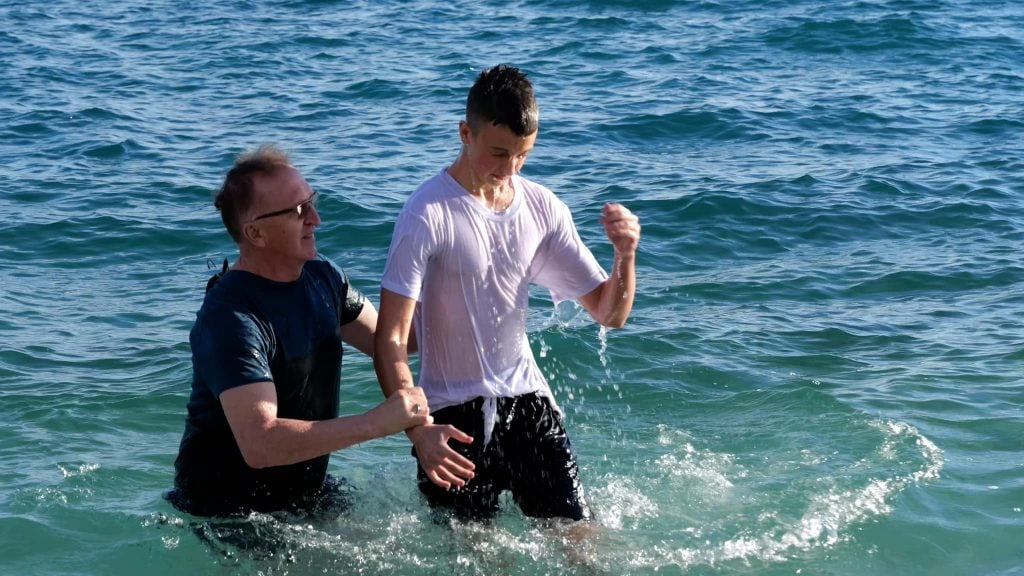 Croatian minister Mladen Dominic baptizes a new believer at a spring camp.