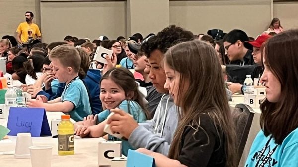 The Bible Bowlers prepare for a three-hour session in the ballroom of the Hilton Anatole Hotel during the 2024 North Texas Leadership Training for Christ convention.