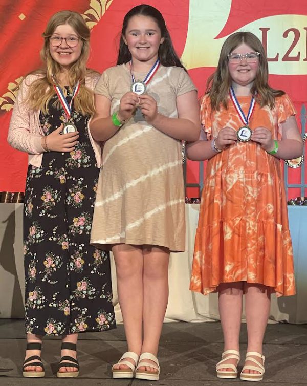 Girls from the Camden Church of Christ in Tennessee receive awards during the Lads to Leaders convention in Nashville, Tenn.