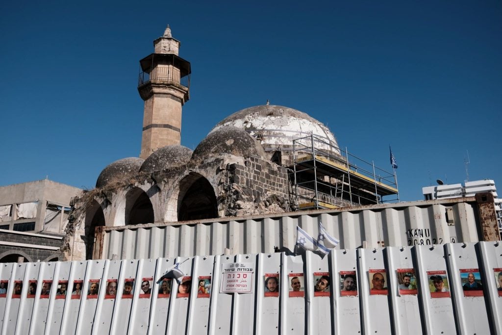Photos of hostages and Israeli flags surround the Great Mosque in Tiberias, Israel.