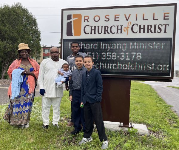 The Inyang family poses for a photo by the Roseville Church of Christ sign. Richard Inyang has served as the congregation’s minister for 15 years.