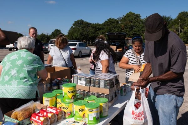 Guests browse the options during the regular Saturday food giveaway of the Bridgewood Church of Christ.