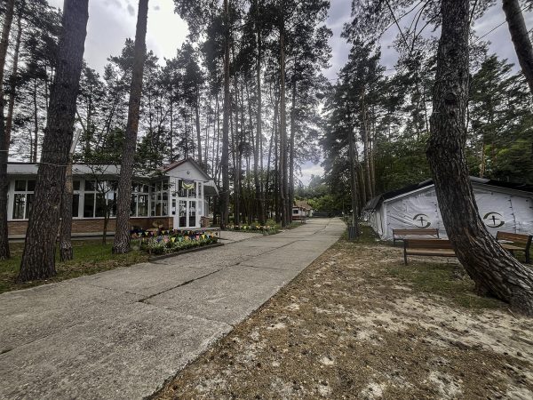 The pavilion where church members once practiced and performed Ukrainian-language hymns, left, now houses boxes of humanitarian aid. Across from the pavilion are tents bearing the logo of relief ministry Samaritan's Purse.